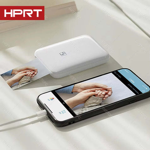 MT53 portable photo printer with smartphone displaying a printed photo, showcasing wireless photo printing technology.